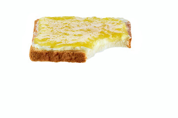 Fototapeta premium Take a bite toasted bread with lemon jam, isolated on a white. Bitten toast with lemon jam on white background.