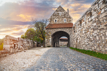 Stone tower of an ancient castle with a passage.