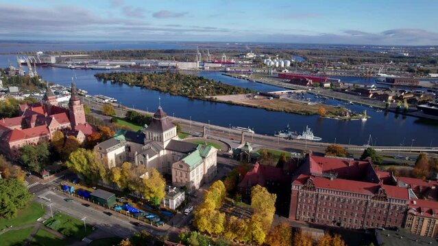 Szczecin from a bird's eye view on a sunny day. View of the city from the Oder River. City buildings, the seaport in Szczecin and its most characteristic places.