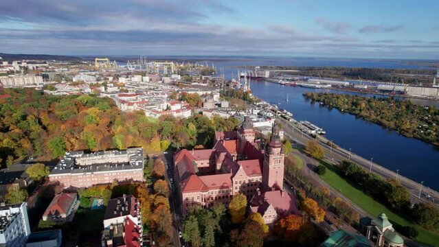 Szczecin from a bird's eye view on a sunny day. View of the city from the Oder River. City buildings, the seaport in Szczecin and its most characteristic places.