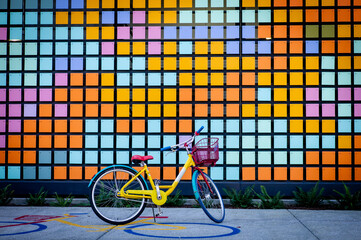 Yellow bicycle in colorful rainbow background