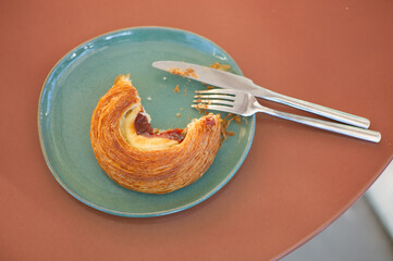 pastry on a plate with forks and knives