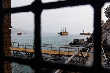 View through the bars of old pirate ships.