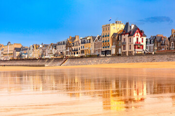 High stone embankment and beach at low tide, in beautiful Saint-Malo, Brittany, France