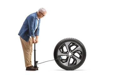 Mature man using a manual pump for a winter car tire