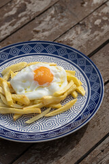 plate with fried egg with potatoes