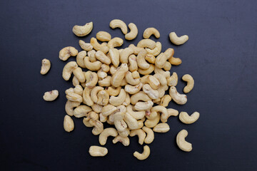 Cashew nuts on dark background.