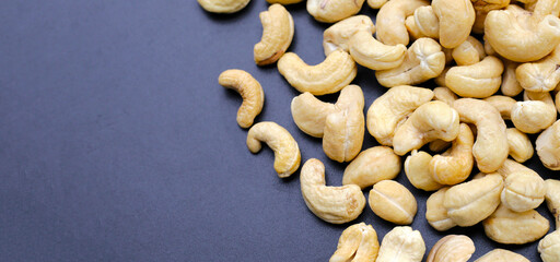 Cashew nuts on dark background.