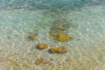 Fototapeta premium Stones in calm sea water.