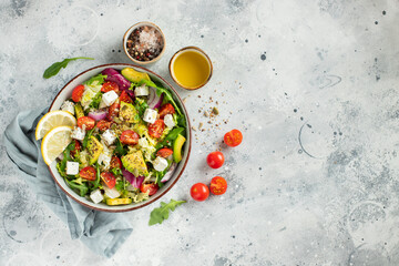 Delicious and healthy green salad of different leaves and vegetables with seeds and olive oil.