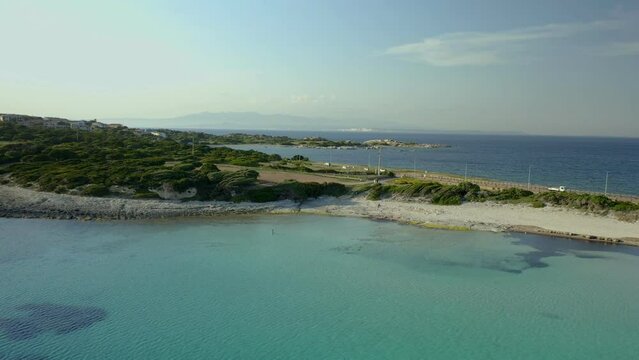 Drone aerial view of Rena di Ponente turquoise water beach in Capo Testa cape in Sardinia, Italy