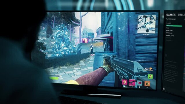 Playing the fake online computer game on the pc screen. Using a heavy rifle to kill online opponents in the fake video game. Collecting the loot from the enemies in the online fake action game.