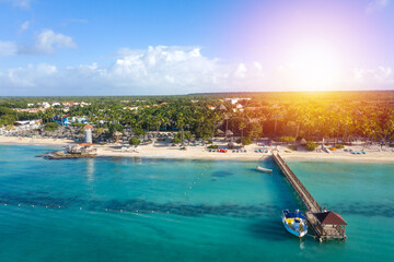 Dominicus beach at Bayahibe with Caribbean sea sandy seashore, lighthouse and pier. Aerial view - obrazy, fototapety, plakaty