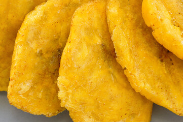Fried platanos on plate. Sliced and cooked tostones