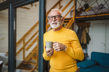 One senior man stand in at door of tiny house happy smile hold cup