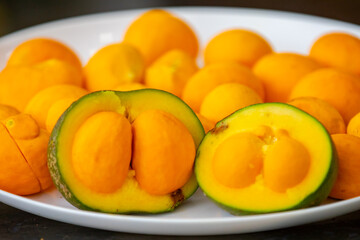 Typical ripe pequi fruit (caryocar brasiliense) in fine details and selective focus. Typical fruit from the Brazilian cerrado bioama.