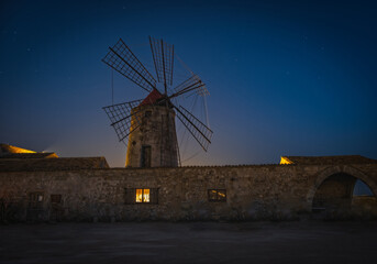 Salt mine and windmill in Trapani at cloudless night. June 2023 © Сергій Вовк
