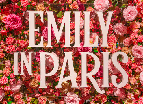 tokyo, japan - may 31 2023: Art installation depicting the title of the American romantic comedy-drama television series Emily in Paris made in polystyrene in front of a pink roses floral background.
