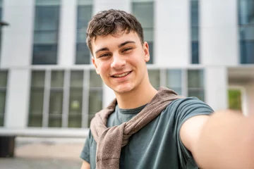 Fotobehang portrait of young Caucasian man teenager 18 or 19 years old outdoor © Miljan Živković
