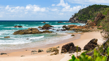 Australian coast, view from a cliff on a sandy beach with a rocky shore on a sunny day. Sea...
