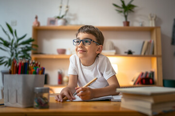 young boy child kid pupil study work on homework assignment at home