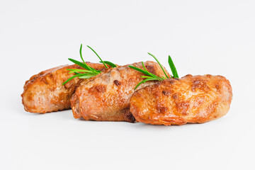 Chicken wings fried until half cooked, semi-finished product with fresh herbs on a white background. Fast food. Fast cooking.Quick cooking at home. Copy space.Fast homemade food.Raw chicken meat.