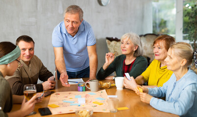Retirees play board games and drink tea with cookies