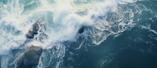 Aerial view of ocean waves crashing on rocks.