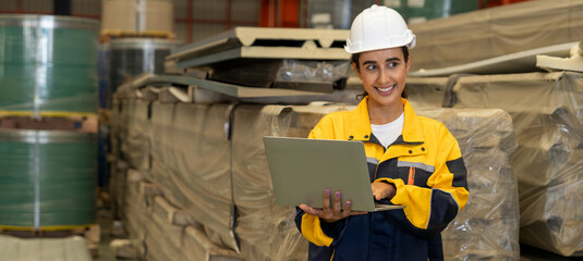 Female engineer or factory inspector conduct inventory check and quality control for metal steel...