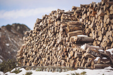 Natural wooden background, closeup of chopped firewood. Firewood stacked and prepared for winter...