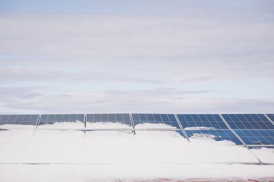 Solar panels under snow in winter. Photovoltaic power plant.Problems in the production of energy covered with snow panels. power plant in ice. A problem, leading to an unstabil energy production