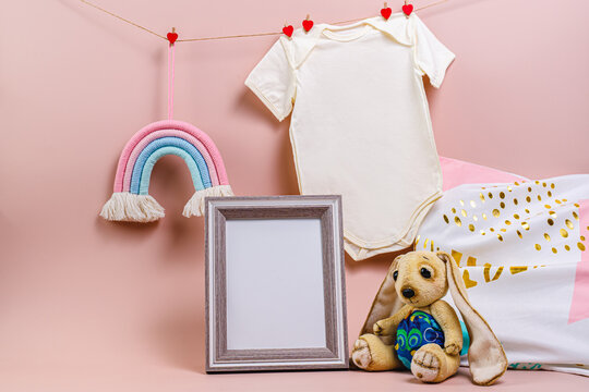 Gender party. Baby bodysuit, rainbow toy, plush bunny, photo frame mockup. Children's room decoration.