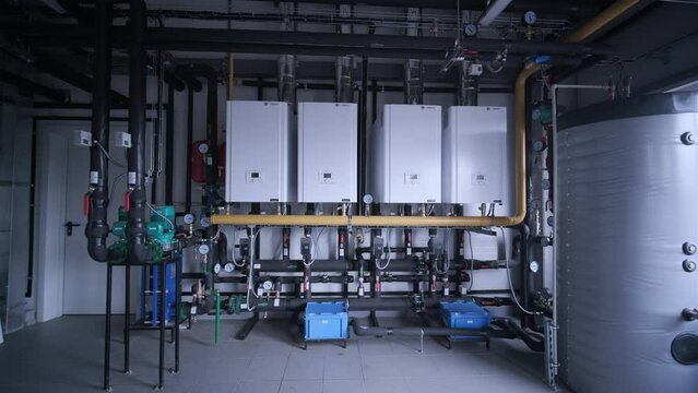 Vinnytsia, Ukraine - October 20, 2023: Modern industrial gas boiler room equipped for heating process. Heating gas boilers, pipelines, valves.
