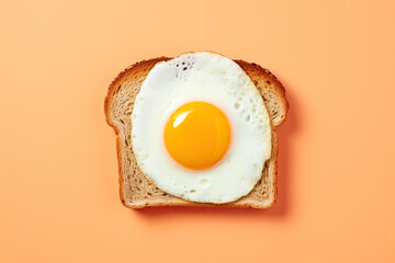 a fresh fried egg with bright yellow yolk on a slice of toast - obrazy, fototapety, plakaty