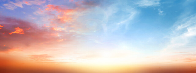 Real amazing panoramic sunrise or sunset sky with gentle colorful clouds