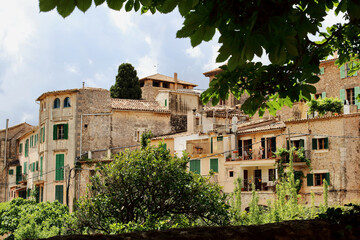 View of idyllic Valldemosa village old houses decorated with seasonal plants and flowers, Mallorca, Balearic Islands, Spain (all brand names and logos have been removed).