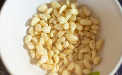 garlic in a white bowl. Close up. Selective focus.