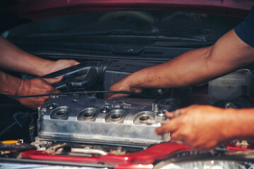 Close up Man hands fixing Car machinery vehicle mechanical service. Mechanic man hands repairing car auto repair shop. open vehicle hood checking up auto mobile. Vehicle Car maintenance engineer.
