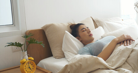 Asian women sleep wake up in white cozy bedroom happy time morning sunrise. Beautiful chinese use...