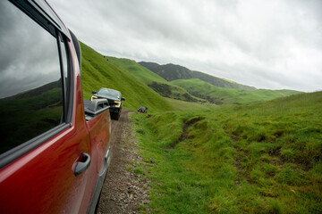 4WD Utes travel in convoy over New Zealand farmland