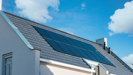 Newly build houses with solar panels attached on the roof, Solar system on a roof , black solar...