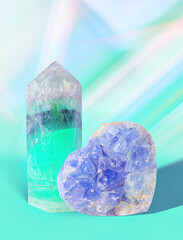 Green Fluorite Healing Crystal and Blue Celestite Quartz Heart Shaped Gemstone on a Green Pastel Background