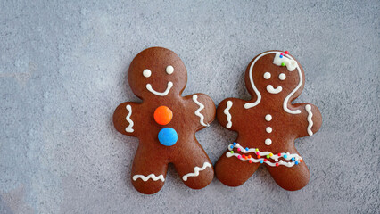 Two of Christmas gingerbread cookies with icing isolated on blurred background, top view, traditional element, Merry christmas, New year and xmas celebration.