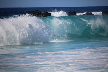 aquamarine waves crashing on the shoreline