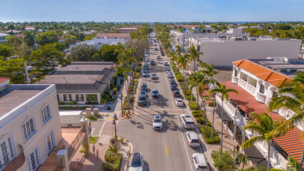 Fifth Avenue Naples Florida USA. Sunny day high angle view of the landmark 5th avenue in Naples with palm tree lined street and waters of Gulf of Mexico on the horizon - obrazy, fototapety, plakaty