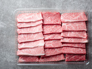Fresh raw meat in a plastic container