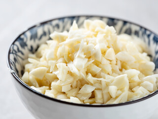 chopped garlic in bowl - Powered by Adobe
