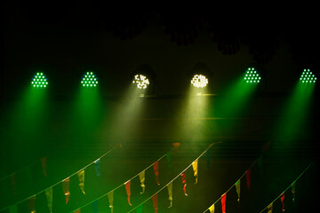 Stage lights on a concert in a theater, Stage lights and smoke stage during concert. Several projectors in dark on the ramp