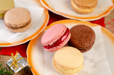 Tasty macaroons cookies in winter, Christmas setup, with pine tree branches 