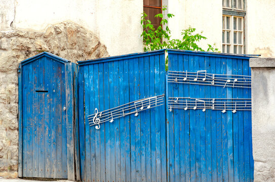 Sfantu Gheorghe, Covasna, Romania, June 16, 2023: Blue musical gate to a historical house, in memory of the Hungarian composer Bartok Bela